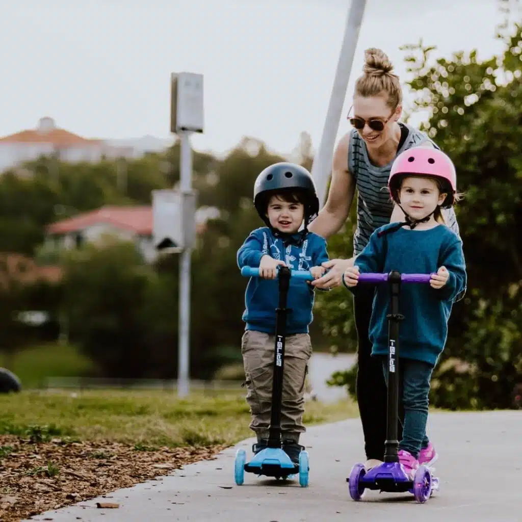 Kids Scooters - brothers riding in the park