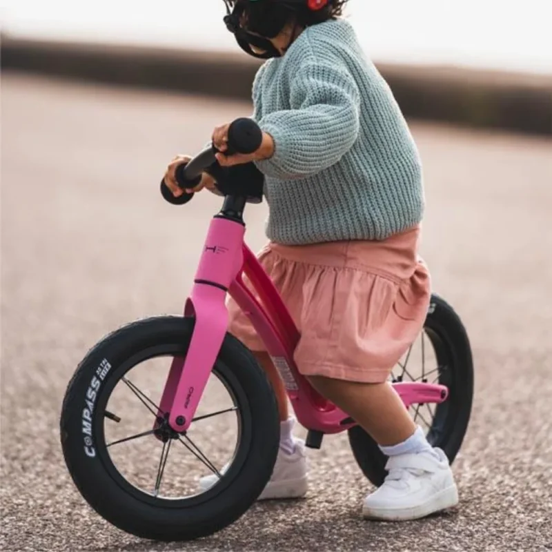 Kid on a Flamingo Pink Airo 12 Inch Balance Bike